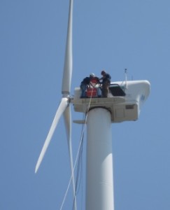 Evan Osler and Alban Jehu work to configure the Wind Iris Lidar on the turbine’s nacelle.